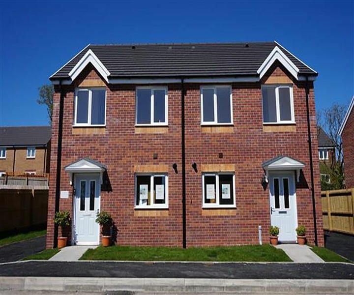 A modern red brick duplex home with two entrances.