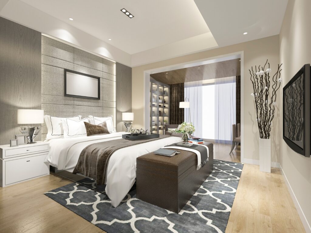A modern bedroom with a stylish bed, wooden accents, and decorative plants.