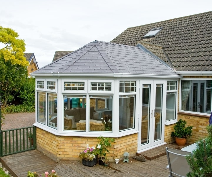 Beautifull and stunning victorian conservatory surrounded by greenery and and houses in neighbours
