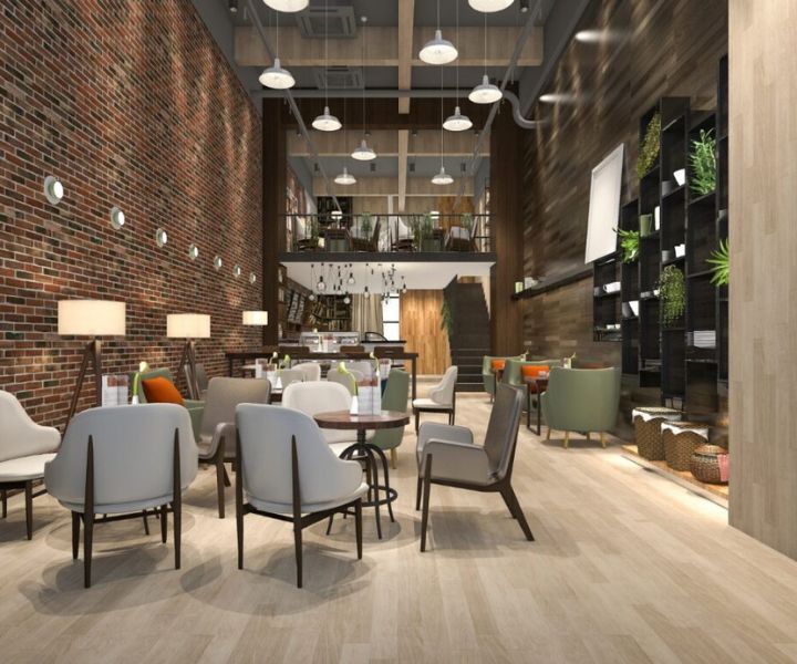Modern industrial-style café interior with cozy seating and warm lighting.