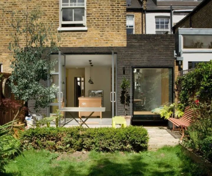 Stylish lean-to side extension with open doors and garden view.