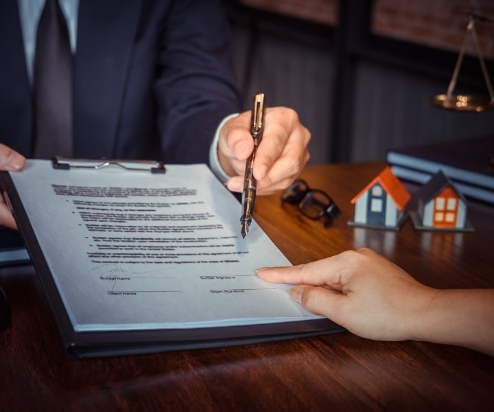 Signing a party wall agreement with a legal professional.