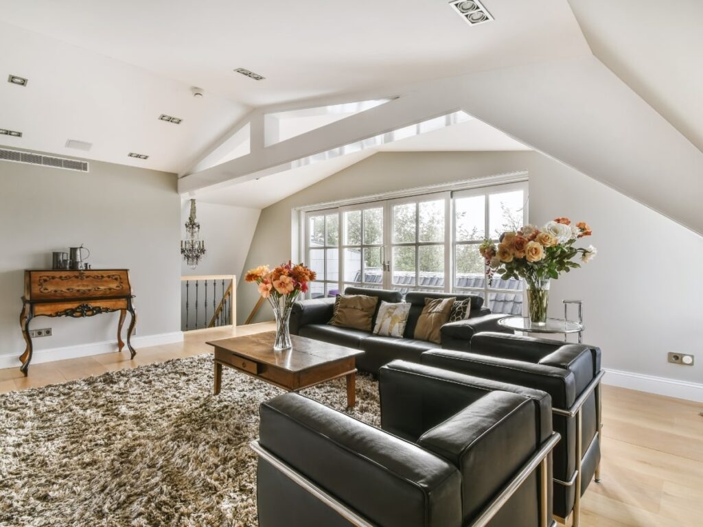 Elegant loft with modern furniture, natural light, and floral accents.