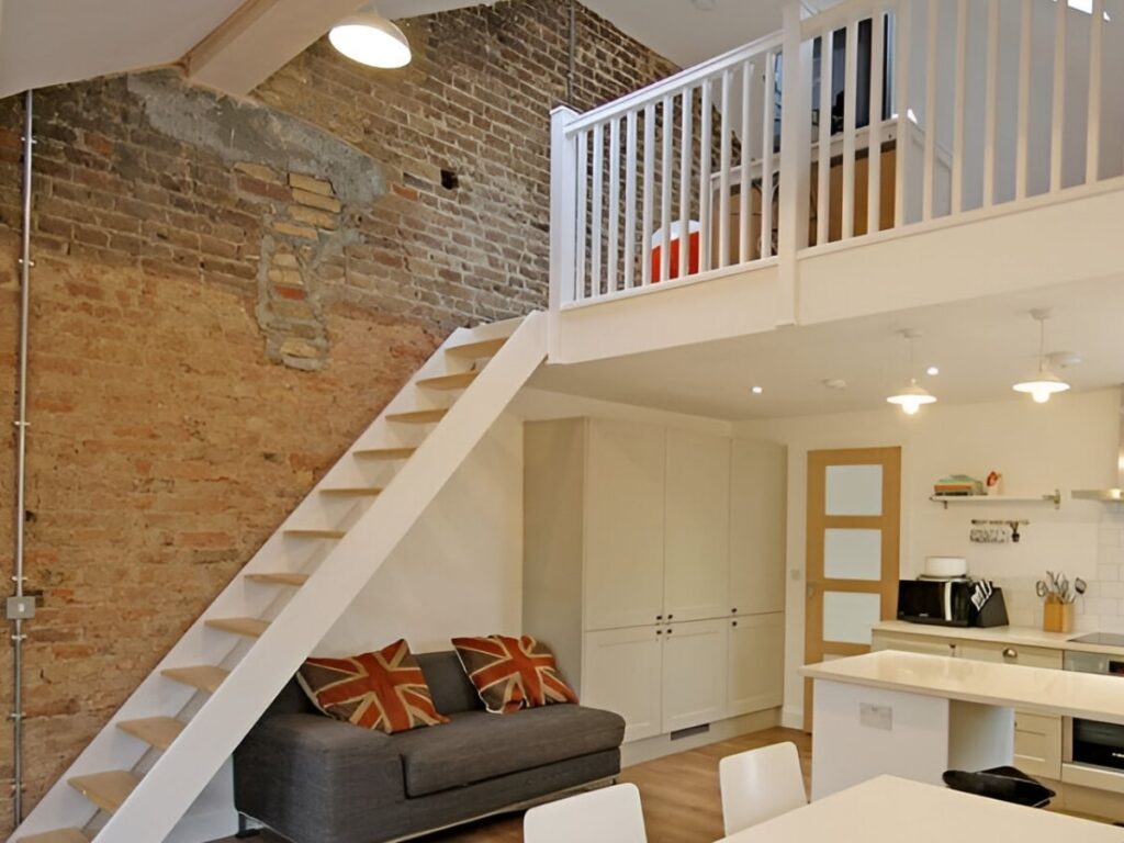 Cosy mezzanine loft with exposed brick wall and stylish decor.